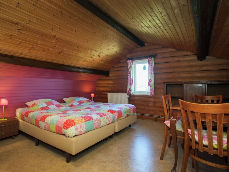 Open Wooden Chalet Built Against A Hill