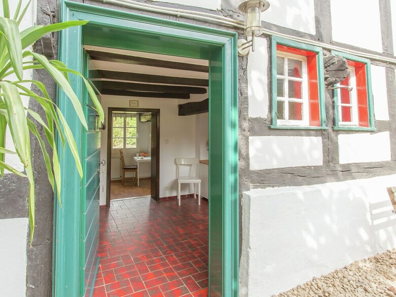 A Lovely Watermill Surrounded By Delightful Greenery