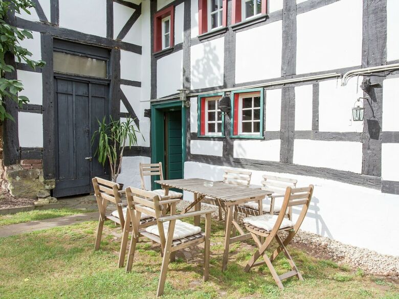 A Lovely Watermill Surrounded By Delightful Greenery