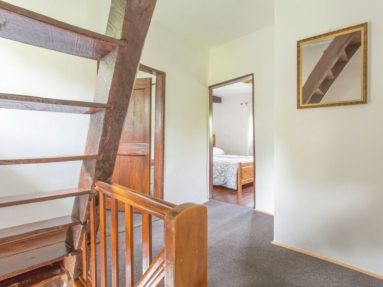 A Lovely Watermill Surrounded By Delightful Greenery