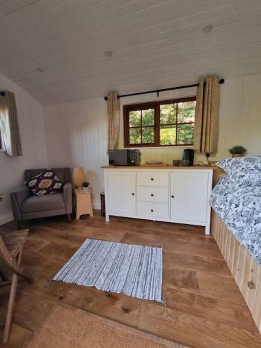 Shepherds Hut Surrounded By Fields And The Jurassic Coast