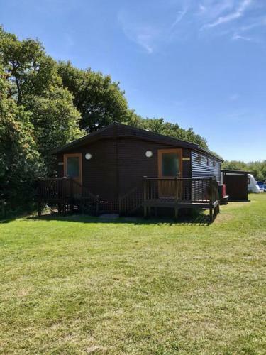 Shepherds Hut Surrounded By Fields And The Jurassic Coast